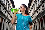 Fitness woman drinking water near uffizi gallery in florence, italy