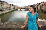 Fitness woman standing in front of ponte vecchio in florence, italy