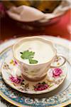 Close-up of Creamy Soup with Herb Garnish in Teacup