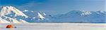 A Backpacking Tent With Snowshoes Next To It With The Alaska Range In The Distance In Winter Isabel Pass Richardson Highway Interior Alaska; Anchorage Alaska United States Of America