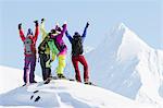 Friends Hanging Out In The Chugach Mountains While Backcountry Skiing By Snowmobile, Late Winter, Southcentral Alaska.