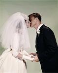 1960s BRIDE AND GROOM KISSING