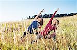 Mature women practising yoga on field