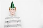 Boy wearing cone party hat