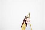 Girl wearing cone party hat