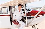 Medical staff delivering supplies in cooler box by plane, Wellington, Western Cape, South Africa