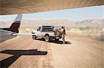 Delivery man loading parcels from airplane to truck, Wellington, Western Cape, South Africa