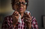 Mature woman with cold reading label on medication