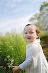 young girl carrying a flower in the country