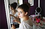 A teenage girl makeup in his room