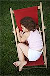 Portait of a 4 years old girl on a lounge chair for child