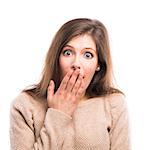 Beautiful young woman with a hand over the mouth astonished with something, isolated over white background