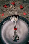 Restaurant series. Valentines day dinner with table setting in rustic wood style with cutlery