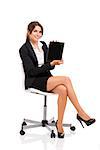 Happy business woman sitting on chair showing something on a tablet, isolated over white background