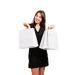 Beautiful and attractive young woman with arms up holding shopping bags, isolated over white background