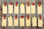 Empty note papers with clothes-peg in shape of train and stars on old wooden background