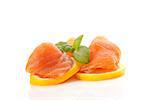 Delicious raw salmon with fresh lemon slices and fresh herbs basil. Culinary seafood background.