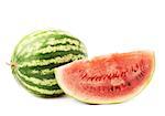 whole watermelon fruit next to a slice, isolated over the white background