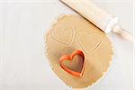 rolled dough with heart-shaped cookie cutter and rolling pin, valentine's day concept