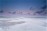 full moon and sunrise sky over sand beach on North sea