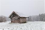 old wooden hut at snowstorm, Bavarian Alps, Germany