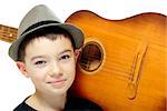 Portrait of eleven years old boy with guitar on white background