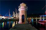 night shot of the lighthouse on the pier