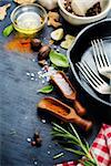 various spices and herbs on a black background