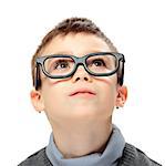 Young boy with glasses looking up isolated on white background