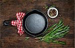 Ingredients for cooking and empty cast iron skillet