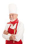 Experienced older chef holding a wooden spoon.  Serious expression, isolated on white.