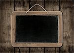 Blackboard on a old dark wood wall background texture