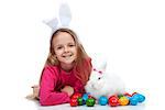 Happy girl with her easter rabbit and colorful dyed eggs - isolated