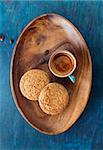 Coffee  in cup  on a wooden tray and cookies . Top view