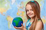 The world in my hands - little girl in geography class holding earth globe, copy space