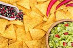 Guacamole in Wooden Bowl with Tortilla Chips and Ingredients Overhead