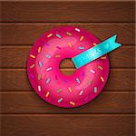 Pink donut on wooden background