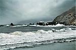 Big wave crashes on to the shore. Coast of Pacific ocean in California