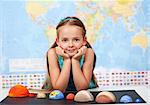 Little girl in elementary science class with her home project - the planets of our solar ystem