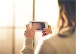 Close-up of a brunette woman holding her phone and texting.