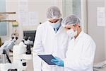 Scientists using tablet in laboratory