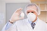 Food scientist holding an egg in laboratory