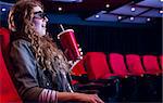 Young woman watching a 3d film at the cinema