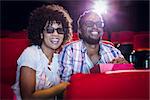 Young couple watching a 3d film at the cinema