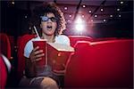 Young woman watching a 3d film at the cinema