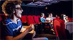 Young friends watching a 3d film at the cinema