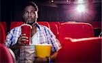 Young man watching a film at the cinema