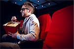Young man watching a 3d film at the cinema