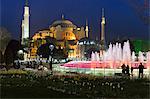 Floodlit domes and minarets of Hagia Sophia mosque museum, UNESCO World Heritage Site, Atmeydani Hippodrome fountain in Istanbul, Turkey, Europe
