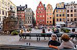 People sitting at Stortorget square in Gamla Stan, Stockholm, Sweden, Scandinavia, Europe